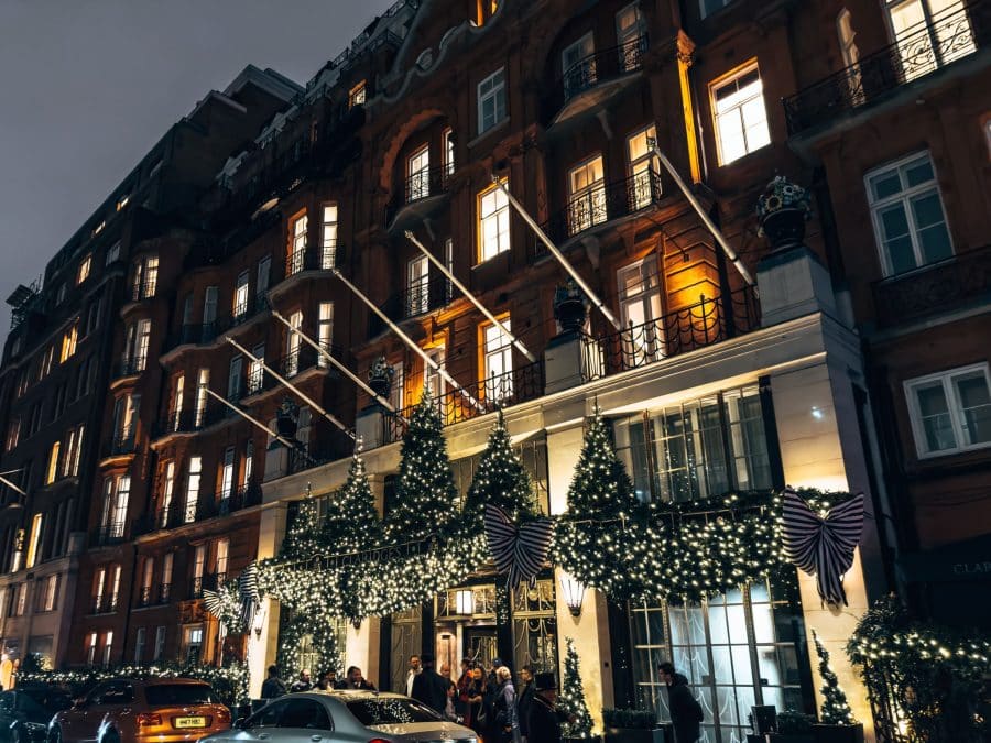 A row of perfectly-trimmed Christmas trees lining the entrance of Claridge's Hotel, best Christmas decorations in London