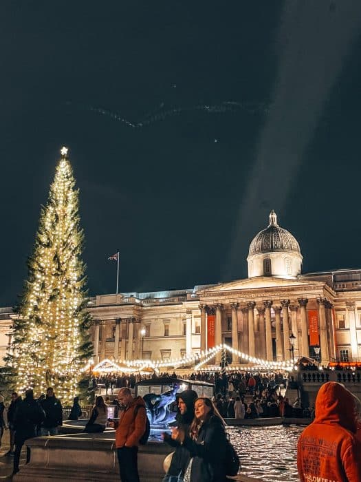 The Trafalgar Square Christmas Tree in front of the National Gallery with Christmas market stalls below, London