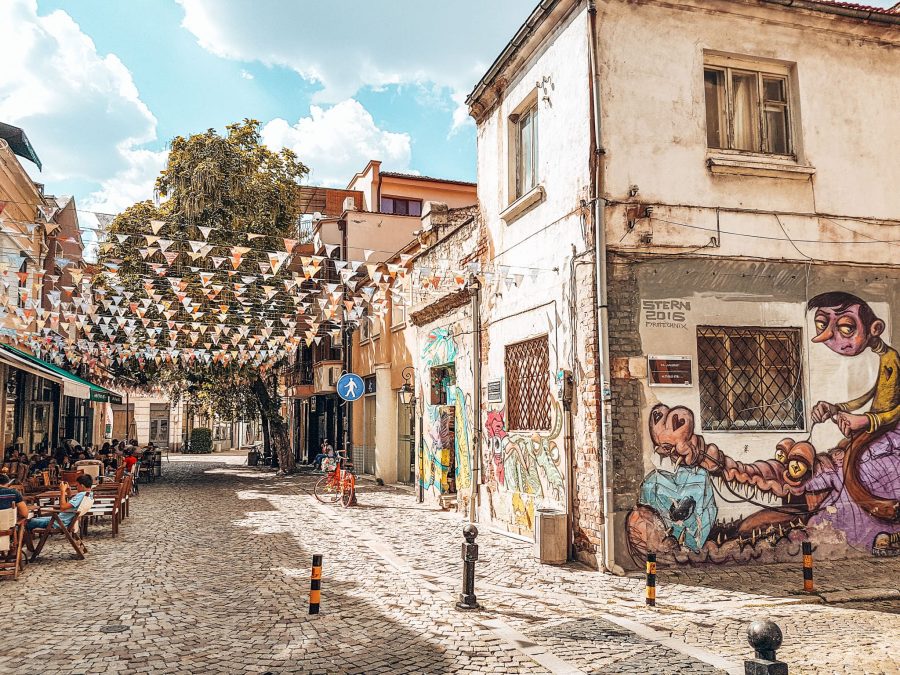 Flag-strewn cobbled streets in Kapana with colourful street art, Plovdiv, places to visit in Bulgaria