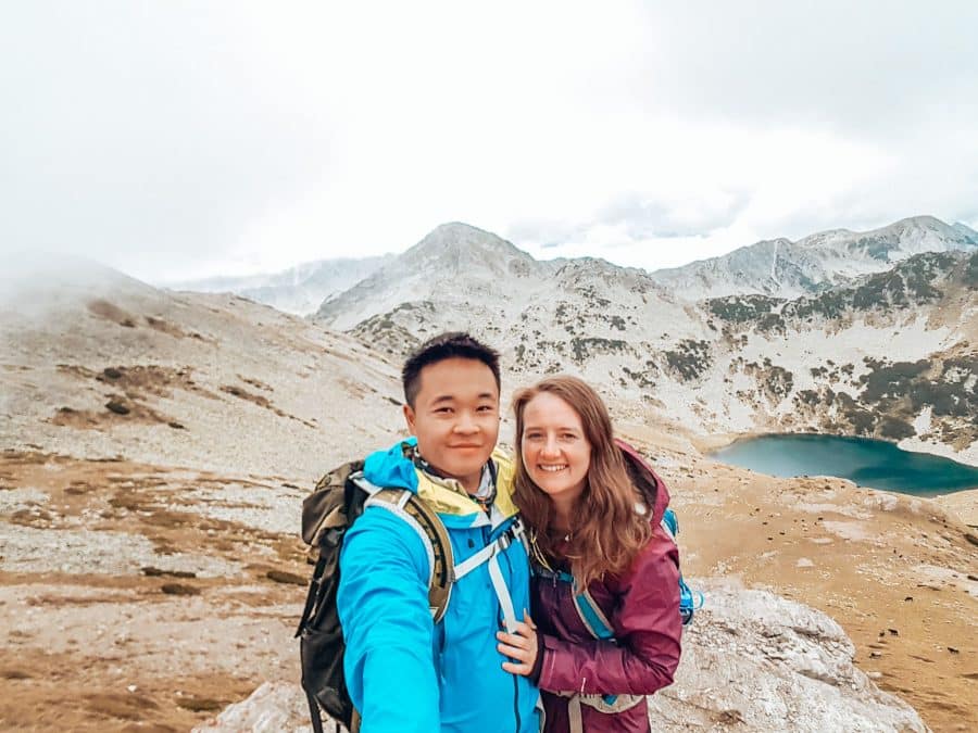 Helen and Andy stood in front of an alpine lake on Mount Vihren, Pirin National Park, Bansko