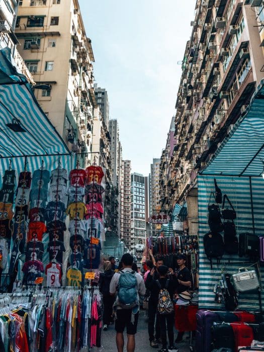 Rows of market stalls nestled at the bottom of imposing skyscrapers, Ladies Market, Things to do in Hong Kong