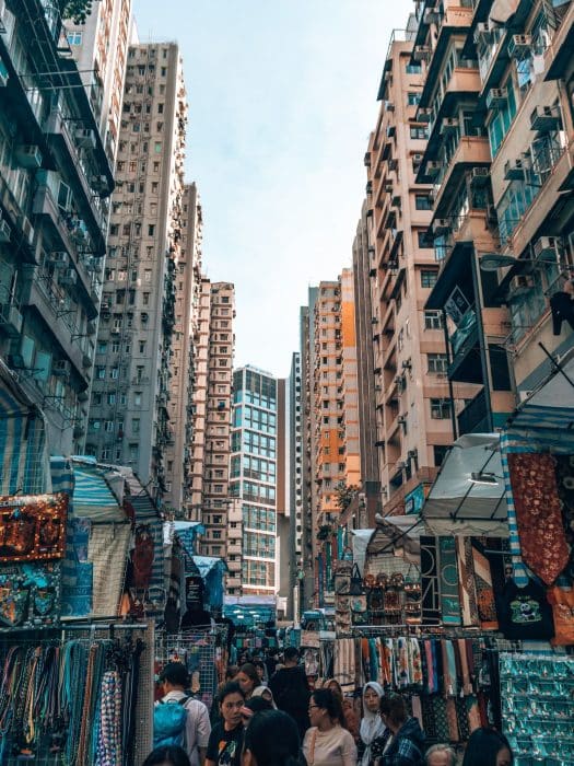 Rows of market stalls nestled at the bottom of imposing skyscrapers, Ladies Market, Things to do in Hong Kong