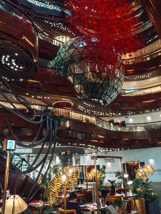 The atchitecturally beautiful interior of the K11 Art Mall with artwork hanging from the ceiling, Kowloon, Hong Kong