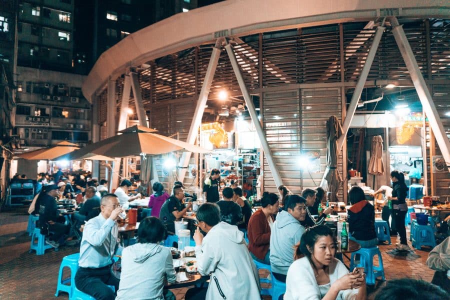 Lots of people sitting at tables at a dai pai dong, Woosung Street Temporary Cooked Food Hawker Bazaar, Hong Kong