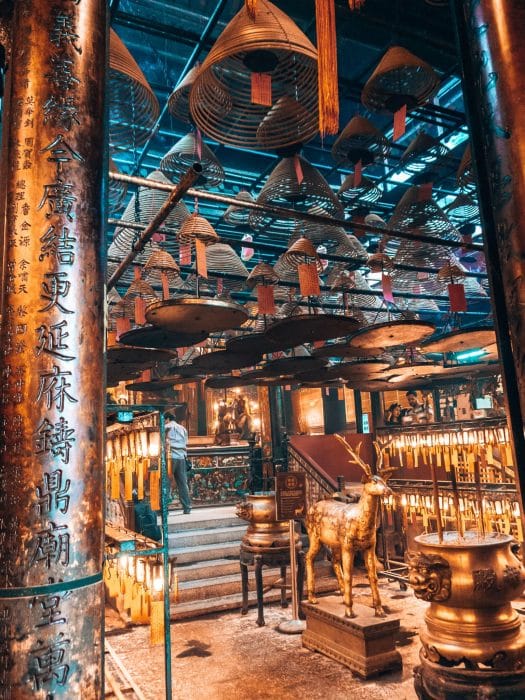 Huge incense coils hanging and burning from the ceiling in Man Mo Temple, things to do in Hong Kong