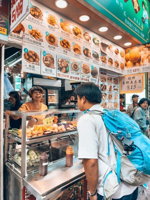 Andy ordering from a street food stall in Kowloon, things to do in Hong Kong