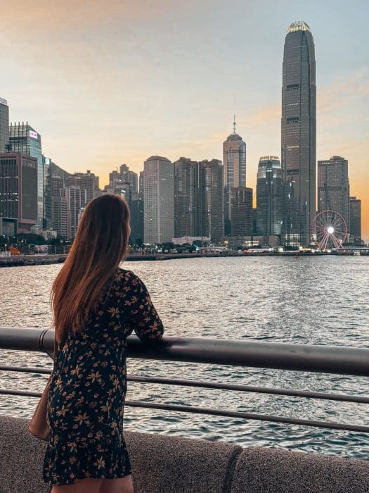 Helen staring out across Victoria Harbour and the skyscrapers on Hong Kong Island from Wan Chai Waterfront, best places to visit in Hong Kong