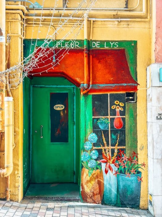 Bright street art with a green door and bright red canopy, ArtLane, Things to do in Hong Kong