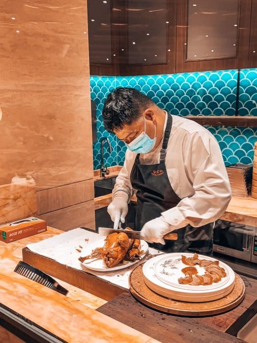 A chef cutting up Peking duck ready to eat, Peking Garden, Hong Kong