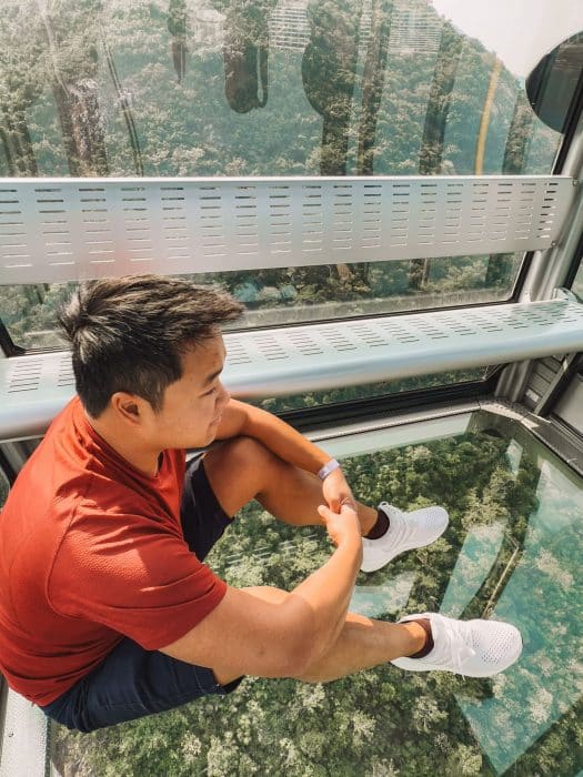 Andy sat on the glass bottom of the Ngong Ping 360, Lantau Island, Best Things to do in Hong Kong