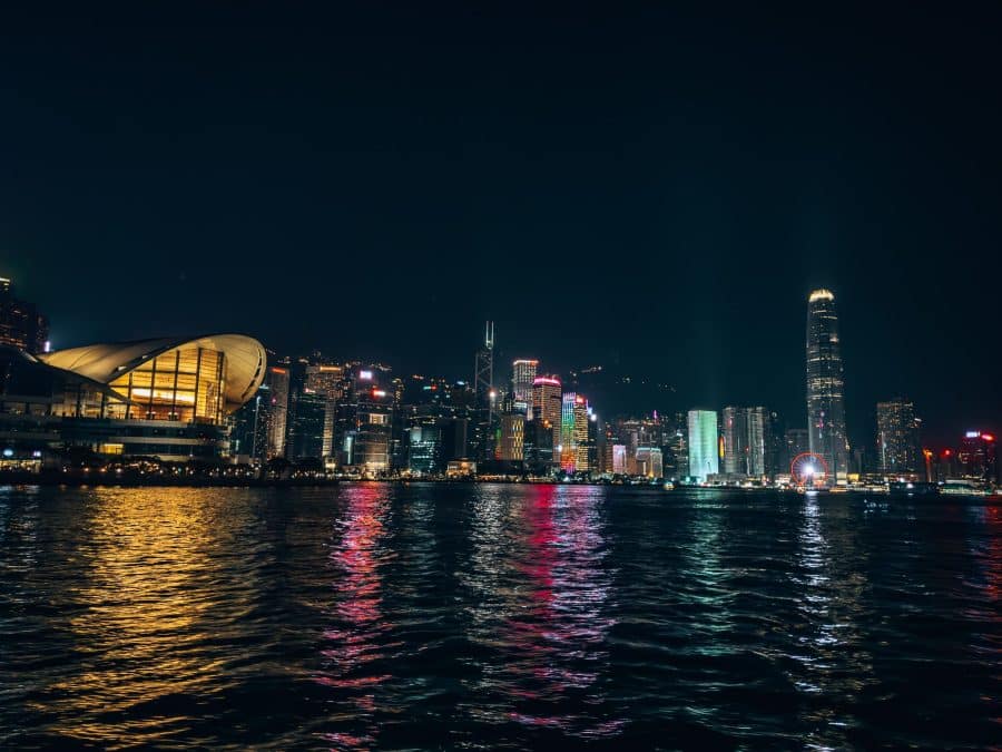 Hong Kong Island's skyscrapers lit up at night while riding the Star Ferry