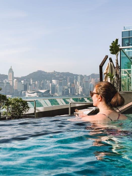 Helen in the outdoor pool overlooking Victoria Harbour and Hong Kong Island, The Kerry Hotel, Kowloon, Hong Kong