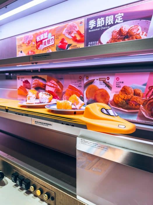 A train on the restaurant's conveyor belt delivering sushi at Genki Sushi, Hong Kong