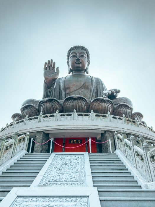 The huge Tian Tan Buddha at the top of stairs towering above us, Lantau Island, Hong Kong Itinerary