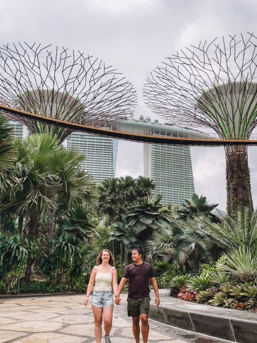 Helen and Andy walking holding hands in the Supertree Grove with Marina Bay behind, Gardens by the Bay, 3-Day Singapore Itinerary