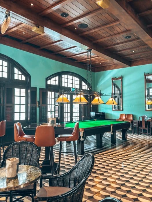 Interior of Long Bar with a pool table and chairs, Raffles Hotel, Singapore Itinerary