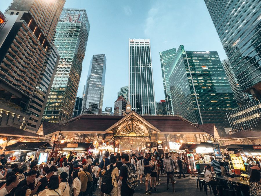 An old one-storey building surrounded underneath huge skyscrapers, Lau Pa Sat, where to eat in Singapore
