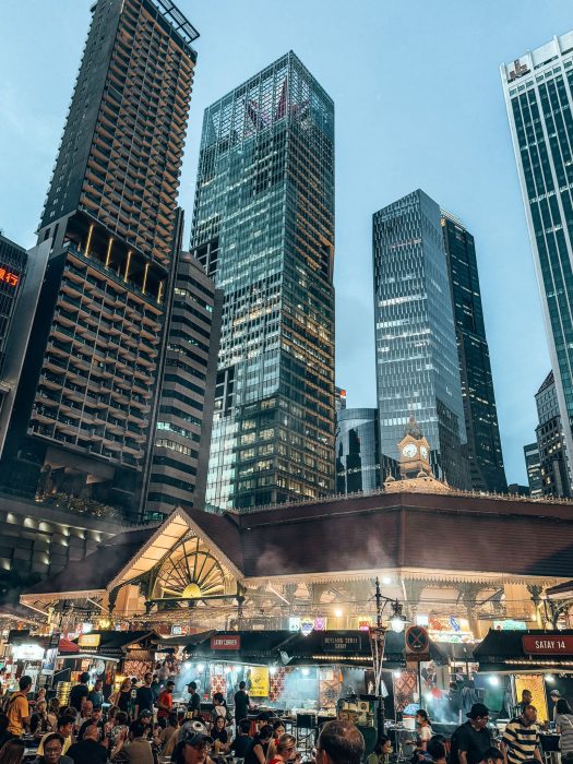 An old one-storey building surrounded underneath huge skyscrapers, Lau Pa Sat, where to eat in Singapore