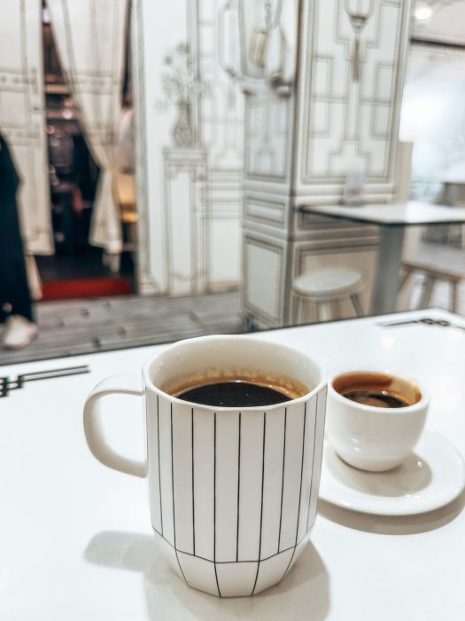 Black and white mugs full of coffee at 2D Cafe, Chinatown, Singapore itinerary