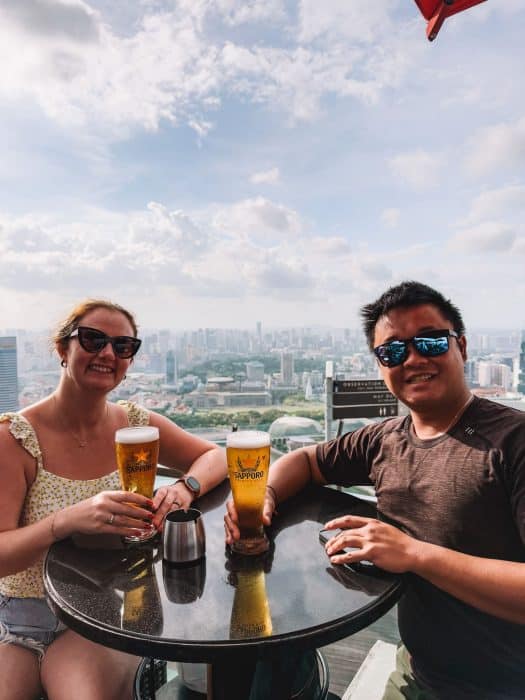 Helen and Andy at Marina Bay Sands rooftop bar nds Rooftop Bar, CÉ LA VI's with drinks, 3-Day Singapore Itinerary