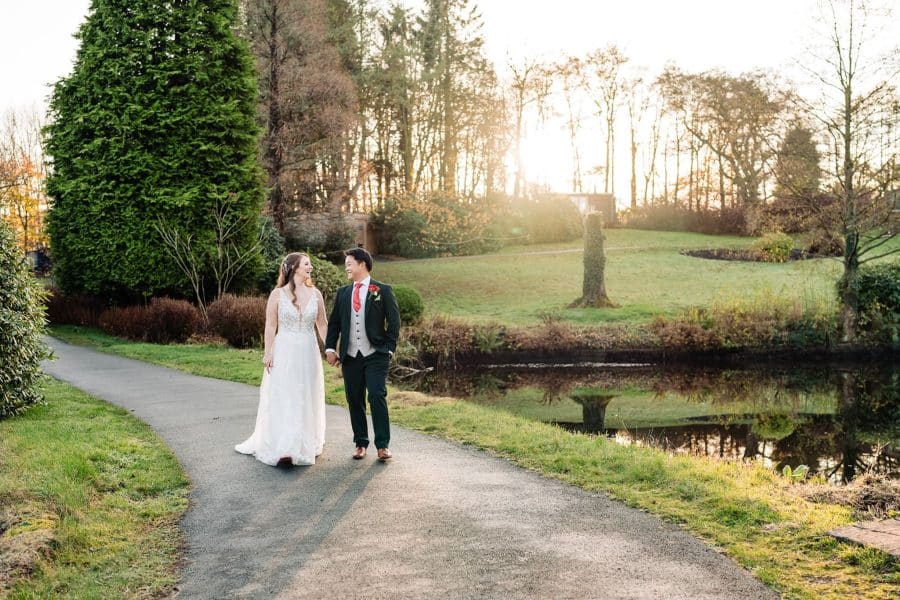 Helen and Andy walking through the Tawny Hotel estate to have our wedding photos taken, Foxtail Barns Wedding