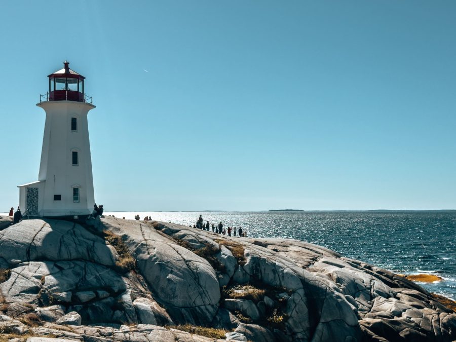 Peggy’s Cove Lighthouse surrounded by rugged granite rocks and ocean — one of the must-see things to do in Nova Scotia, Canada