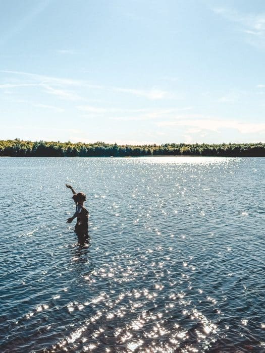 Helen in Kejimkujik Lake surrounded by trees, Kejimkujik National Park, Nova Scotia road trip