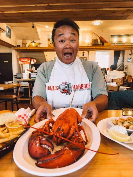 Andy with a huge fresh lobster at Halls Harbour, Places to Visit in Nova Scotia, Canada