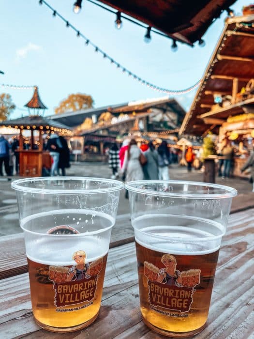 Two beers on a table in the Bavarian Village at Winter Wonderland, best things to do in London at Christmas time