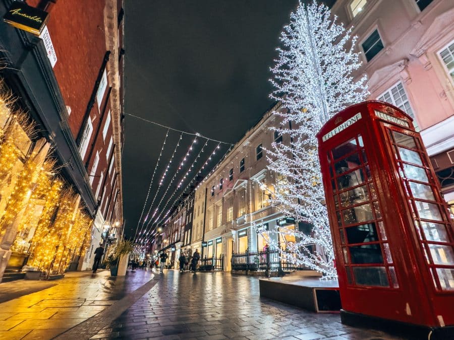 A white Christmas tree and red telephone box on South Molten Street, best places to visit in London at Christmas