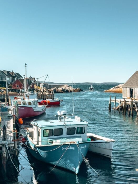 Fishing boats in the ocean in Peggy's Cove, best places to visit in Nova Scotia, Canada