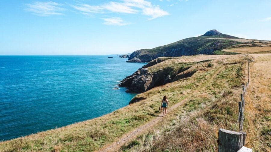 Helen walking along the Pembrokeshire Coast Path next to the ocean